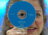 A woman holds a prototype of a 50 Gigabyte 'Blu-Ray' DVD from Sony. Image by Reuters.